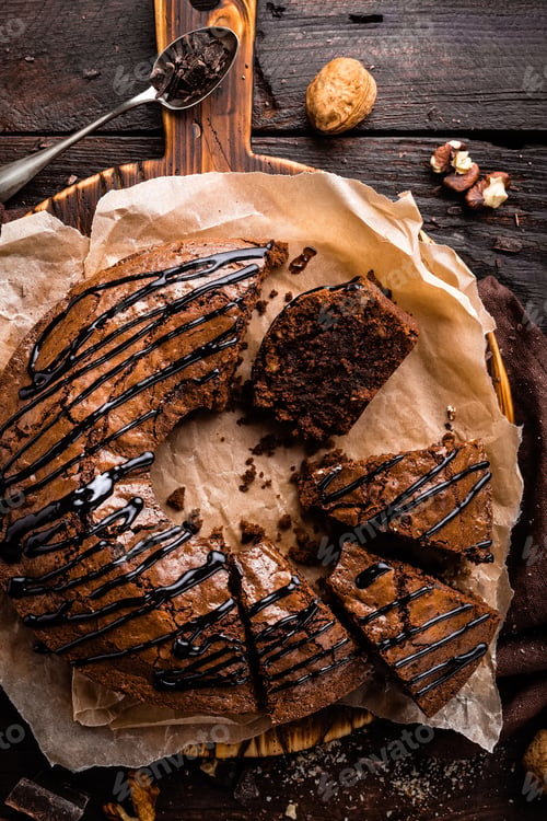 Preview: Chocolate brownie cake, dessert with nuts on dark background, top view