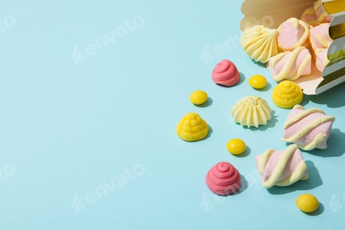 Preview: Jelly candies and marshmallows on blue background, space for text