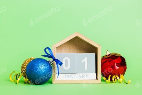 Preview: 1 january. Christmas composition on colored background with a wooden calendar