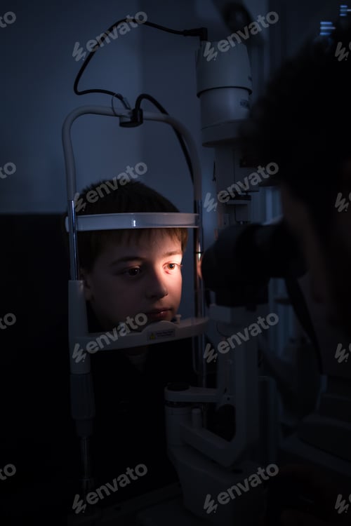 Preview: Optician testing a boy's eyes