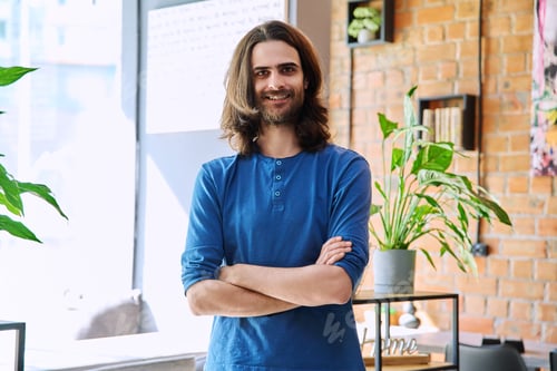 Preview: Portrait of young confident happy man with crossed arms, looking at camera