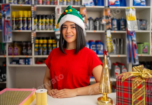 Preview: Saleswoman smiling at camera with decorated counter in auto parts store