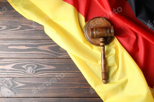 Preview: Judge's gavel and flag of Germany on wooden table, top view. Space for text