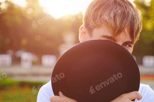 Preview: Beautiful woman hiding face behind hat showing eyes