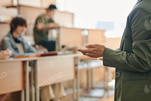 Preview: Hand of young confident female teacher in dark green jacket making report