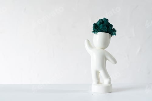 Preview: White ceramic figurine of human with colorful stabilized moss from head is standing with hans up.