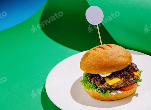 Preview: Juicy burger with cheese and fresh vegetables on a plate