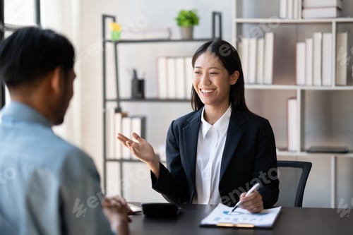 Preview: Young smart businesswoman explaining her ideas of the project to her male coworker at the office.