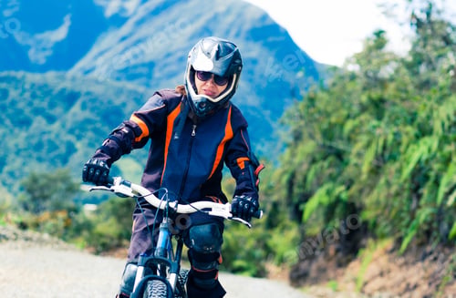 Preview: Girl riding a bike on the background of mountains
