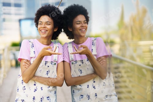 Preview: Laughing black woman near glass building