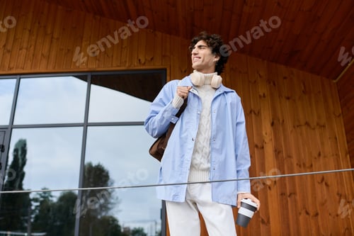 Preview: Handsome young man enjoying a moment outdoors in a vibrant urban setting