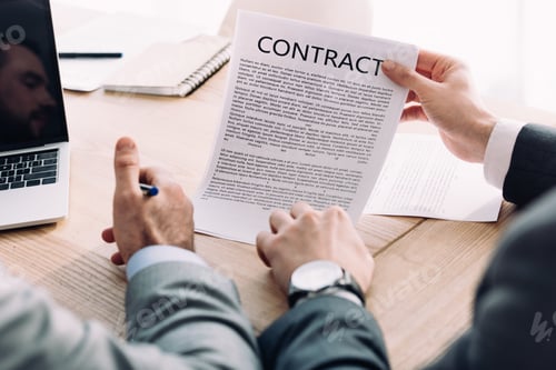 Preview: cropped image of businessman showing contract to colleague in office