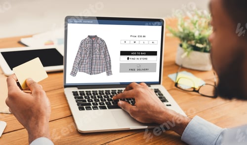 Preview: African Man Shopping Online On Laptop Holding Credit Card Indoors