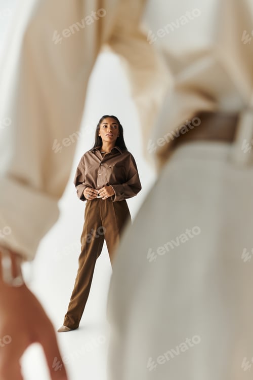 Preview: A stylish young woman stands confidently in a modern space while embracing unique fashion trends