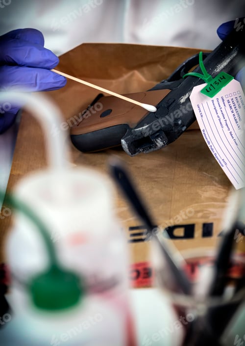 Preview: Police scientist analyzes gunpowder evidence with isopo in crime lab, conceptual image