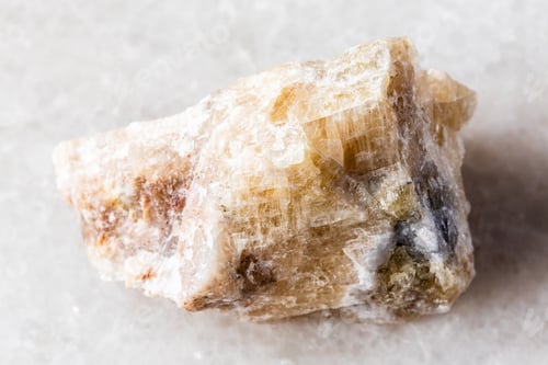 Preview: sample of raw cancrinite rock on white marble