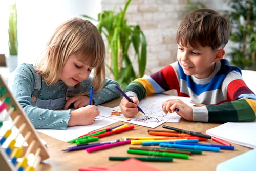 Preview: Smiling sibling doing homework together
