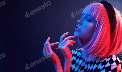 Preview: Portrait of young girl with blond hair in red and blue neon in studio
