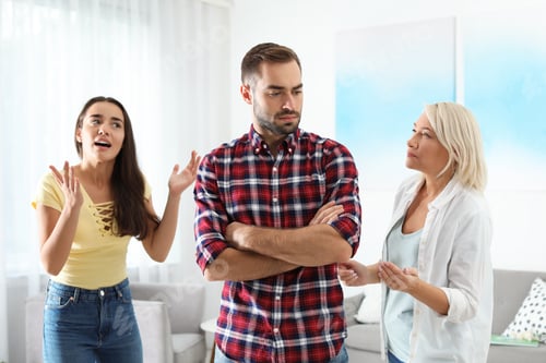 Preview: Young man having argument with wife and mother-in-law at home. Family quarrel