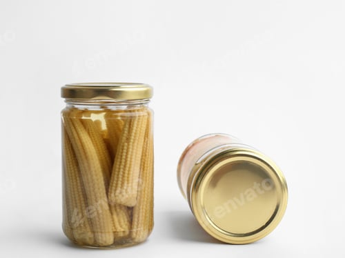 Preview: Glass jars with pickled baby corn on white background