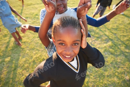 Preview: Elementary school girl posing to camera outdoors, high angle