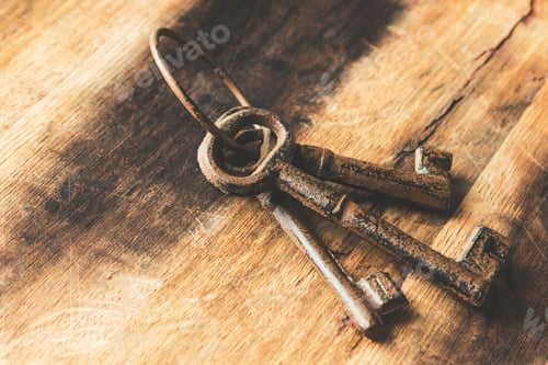 Preview: Closeup shot of old rusted keys on a wooden surface