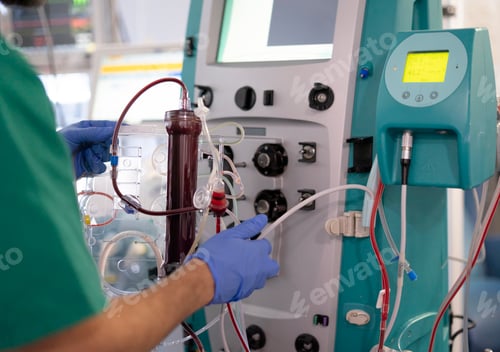 Preview: Doctor operating blood transfusion machine in hospital setting