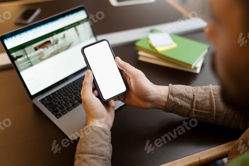 Preview: Man holding mobile phone with blank, white screen. Businessman works at workplace, online shopping