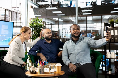 Preview: Happy businesspeople in startup company talking selfie photo with smartphone