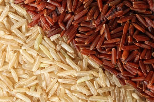 Preview: Brown and other types of rice as background, closeup