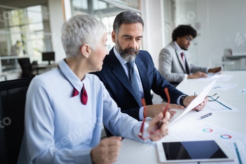 Preview: Group of happy business people working in a meeting at office
