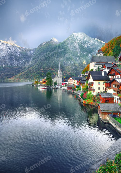 Preview: view of famous Hallstatt lakeside town reflecting in Hallstattersee lake in the Austrian Alps