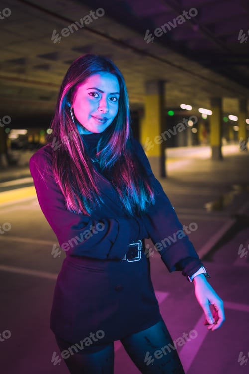 Preview: Portrait of young brunette Caucasian model at night in an underground parking lot