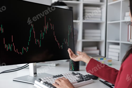 Preview: Close up view of young business woman explaining the trend of the graph to her coworker using