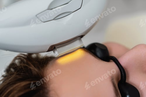 Preview: Phototherapy, photorejuvenation, IPL in a beauty salon. Care for a woman's face.