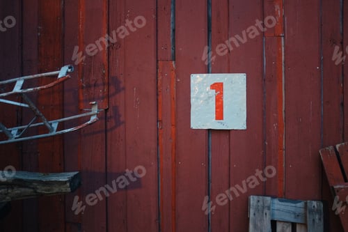 Preview: sign with red number one hanging on a red wooden wall