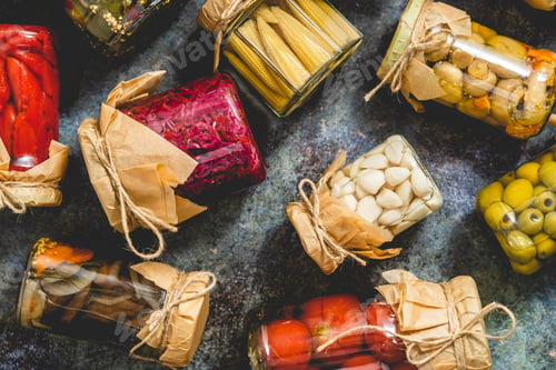 Preview: Closed pickling jars with various vegetables on stone table
