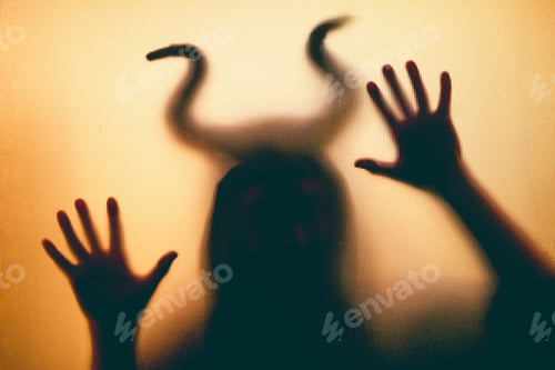 Preview: Horror, halloween background - Shadowy figure with horns behind the glass