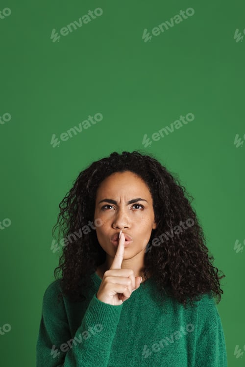 Preview: Young black woman frowning and making silence gesture