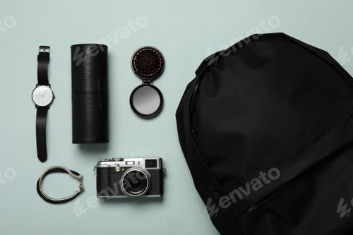 Preview: Stylish urban backpack with different items on light background, flat lay