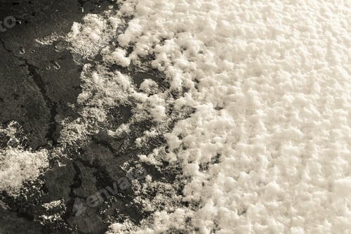 Preview: Abstract Friable Texture Of Sparkling Snow Of Beige Color On Dark Glass