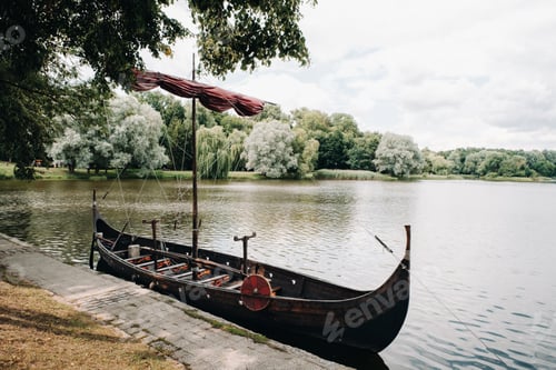 Preview: An antique Viking ship on the river. Old boat