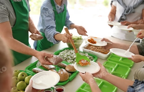 Preview: Volunteers serving food for poor people indoors