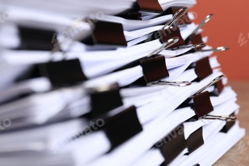 Preview: Binder clips with sheets of paper on table, closeup