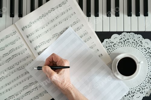 Preview: hand holds a pen and writes notes on the stave next to the piano keys