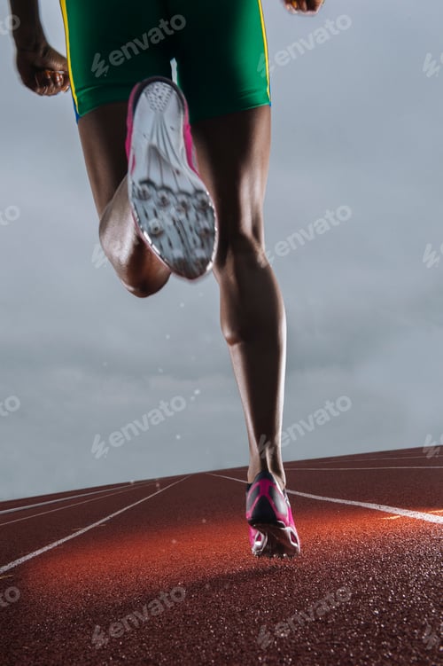 Preview: Rear view of young female athletes legs running on race track