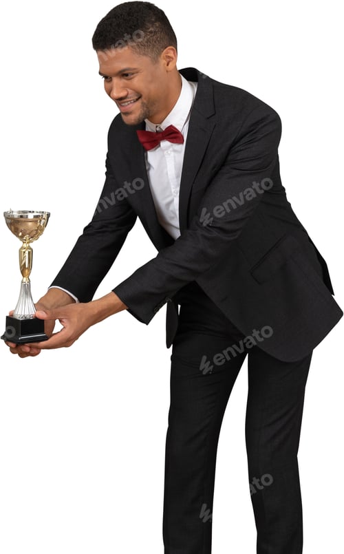 Preview: a man in a suit holding a trophy