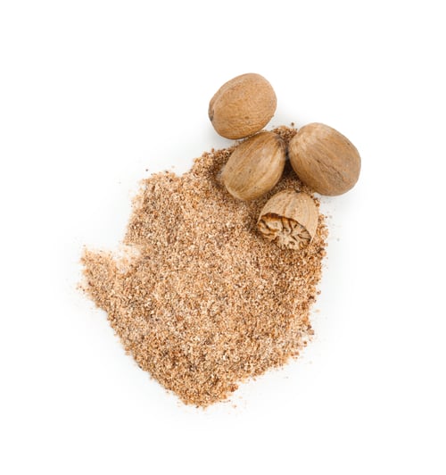 Preview: Whole, cut nutmegs and powder isolated on white, top view