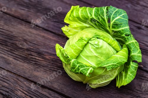 Preview: Green fresh cabbage head on wooden surface