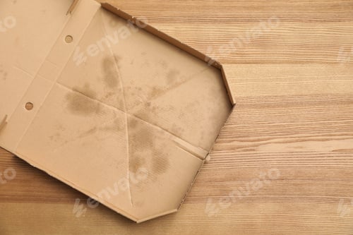 Preview: Cardboard pizza box on wooden background, top view with space for text